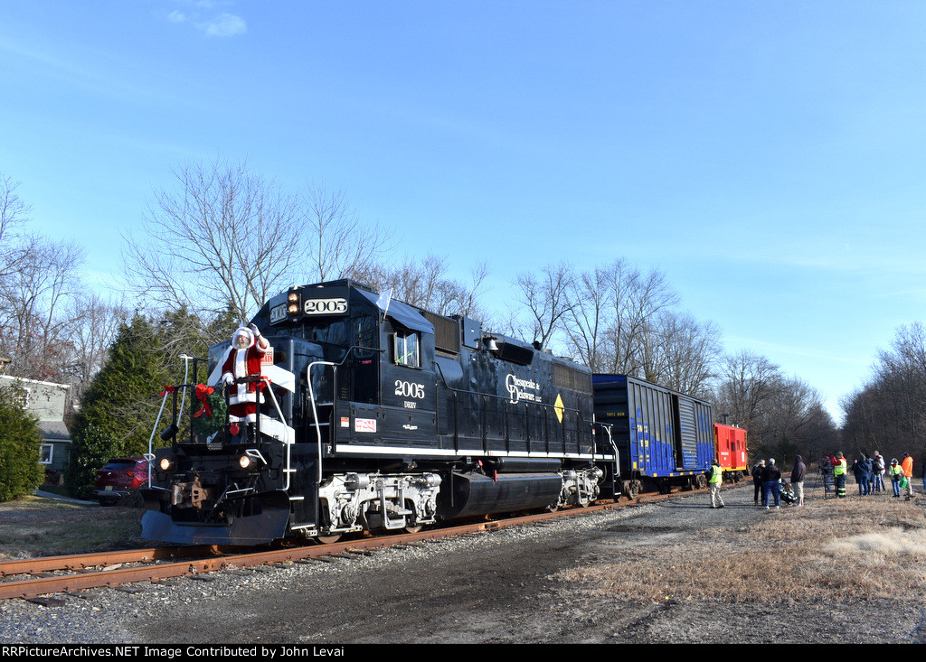 Entering the stop adjacent to Reed & Perrine Co. Store in Tennent with GP38-2 # 2005 on the point-note Santa waving